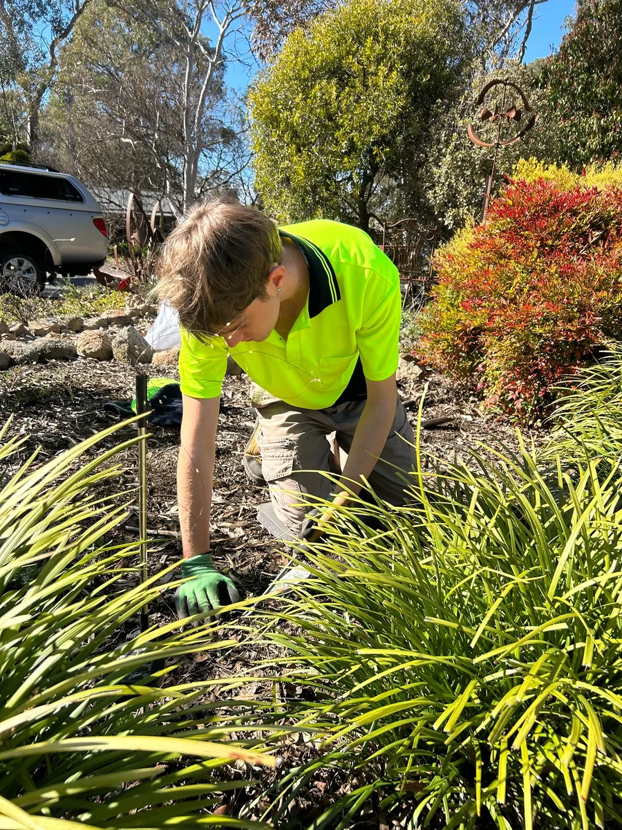 Crew member Anthony caring for a garden