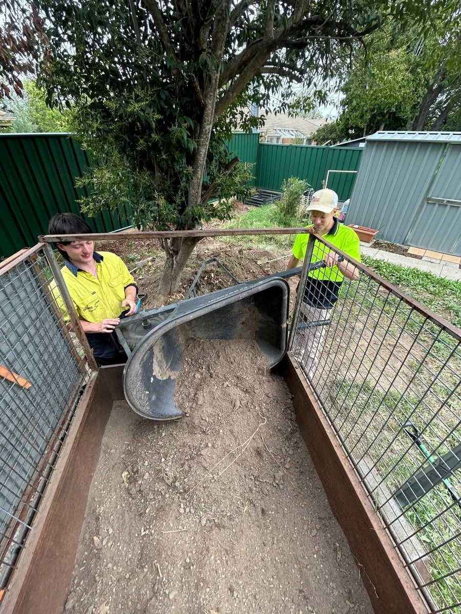 Crew members removing excess soil